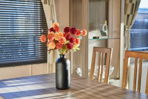 a vase filled with flowers sitting on a table at Host & Stay - 10th Avenue in Morpeth +16 photos