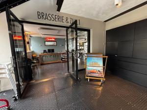 an entrance to a shopping mall with a sign for a restaurant at Hotel Oostereiland in Hoorn