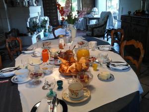 a table with a table cloth with food on it at LES Roses Trémières in Gémozac