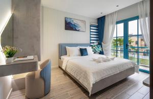 a bedroom with a bed and a large window at Suri Villa in Bình Tú