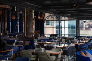 a restaurant with blue chairs and tables andwindows at Metropolitan Hotels Bosphorus - Special Category in Istanbul
