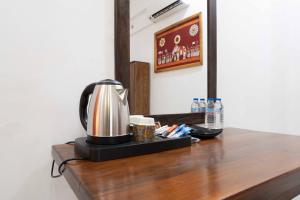 a coffee maker on top of a wooden table at Urban Kandy City Hotel in Kandy