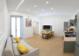 a living room and kitchen with a couch and a table at Palazzo Ducale in Salerno