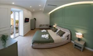 a bedroom with a large bed with two pillows at Palazzo Ducale in Salerno