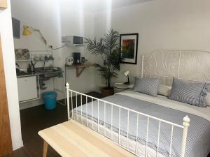 a bedroom with a white bed and a sink at La SELVITA in Bajamar