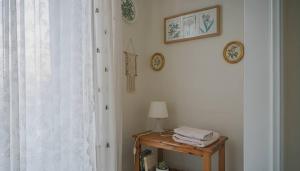 a room with a table with a lamp and a window at Spacious Residence in Rafina with Panoramic Views in Rafina