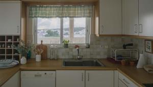 a kitchen with a sink and a window at Spacious Residence in Rafina with Panoramic Views in Rafina