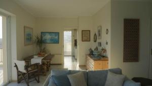 a living room with a couch and a table at Spacious Residence in Rafina with Panoramic Views in Rafina