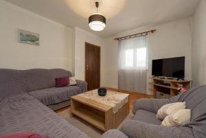 a living room with two couches and a coffee table at Holiday Home Vala in Vinišće