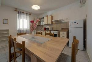 a kitchen with a large wooden table and a refrigerator at Holiday Home Vala in Vinišće +13 photos