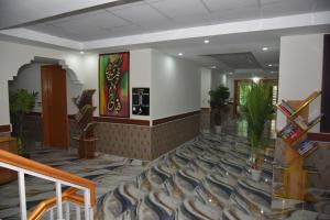a lobby of a hotel with stairs and plants at Luxury Stay Near Neelum River Valley,208 in Muzaffarabad