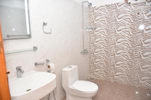 a bathroom with a shower with a toilet and a sink at Luxury Stay Near Neelum River Valley,208 in Muzaffarabad +6 photos