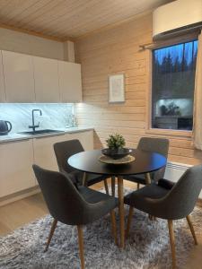 a kitchen with a table and chairs in a room at Villa Lyxfällan in Kimitoön