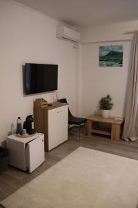 a living room with a flat screen tv on the wall at Parlament Residence in Bucharest