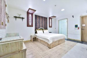 a bedroom with a bed and a bath room at 필사랑무인텔 in Wŏndang-gol