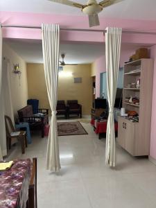 a living room with white curtains in a room at Single Bedroom to rent in Two bedroom apartment in Udupi +7 photos
