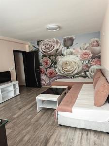 a bedroom with a flower mural on the wall at Palma in Burgas