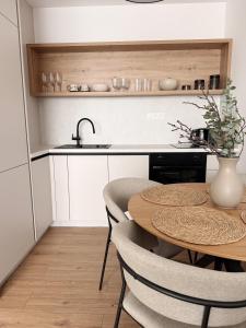 a kitchen with a table and chairs and a sink at apartman Sole in Trnava