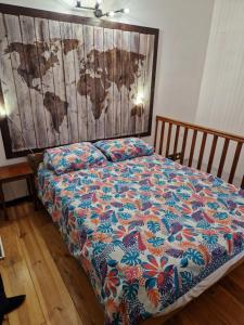 a bed in a room with a blanket on it at Gîte Moulin de l'Anet in Goult