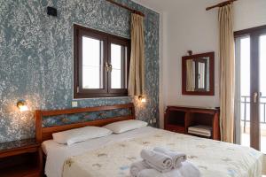 a bedroom with a bed with two towels on it at Kiwi Kastle in Nea Fokea +116 photos