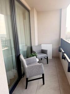 a room with two chairs and a window at apartman Sole in Trnava