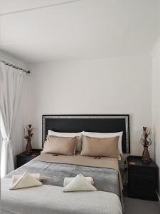 a bedroom with two beds with towels on them at Somerset west Stay 1 in Somerset West +42 photos