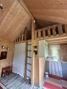 an interior of a cabin with a wooden ceiling at Cozy Off-Grid Cabin - No Power, No Running Water in Skretteberg