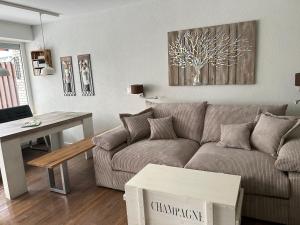 a living room with a couch and a table at App 624 Panoramic Hohegeiß Terrassenhaus in Braunlage
