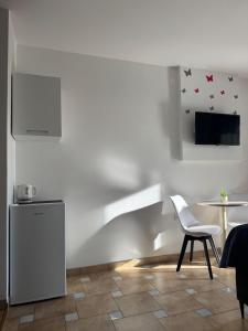 a kitchen with a chair and a table and a tv at Villa Šimović in Baška Voda +30 photos