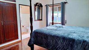 a bedroom with a bed with a blue comforter at Casa da Maíssa in Ponta Delgada