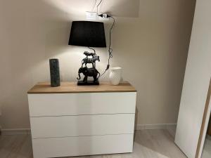 a table with a lamp on top of a dresser at Parrot House in Bertinoro