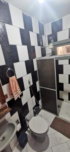 a bathroom with a toilet and a shower at Verde & Sal 11 in Ilhéus