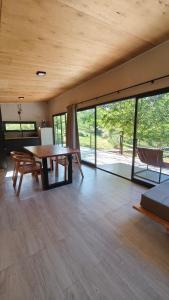 a room with a table and a bed and glass doors at Aire in La Estancia