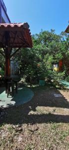 a park with a picnic table and a canopy at Verde & Sal 11 in Ilhéus