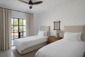 a bedroom with two beds and a window at Huis Prins in Prince Albert