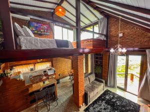 a room with a loft with a bed on the wall at Pousada e Restaurante Vista Turquesa in Arraial do Cabo