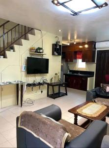 a living room with a couch and a television at Townhouse in Agus