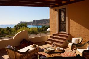 a balcony with stairs and a view of the ocean at Palazzo Navarone in Lindos