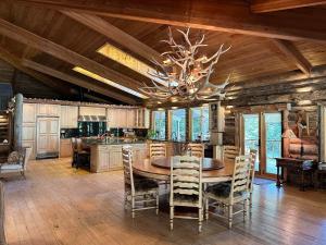 a dining room with a table and chairs and a chandelier at Skyline Ranch in High Rolls