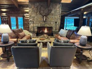 a living room with a couch and a fireplace at Skyline Ranch in High Rolls