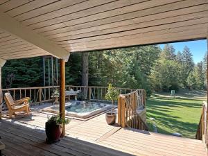 a large wooden deck with a hot tub on it at Skyline Ranch in High Rolls