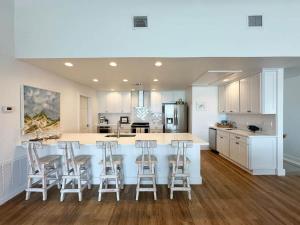a kitchen with a large island with bar stools at Blue Heron Hideaway in Rockport