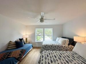 a bedroom with two beds and a ceiling fan at Blue Heron Hideaway in Rockport +4 photos