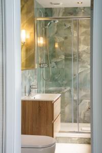 a bathroom with a shower and a sink and a toilet at The Parliament House Hotel in Edinburgh