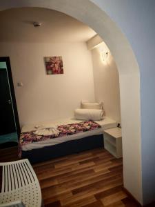 a small bedroom with a bed in an archway at Chance Sarafovo in Burgas +96 photos