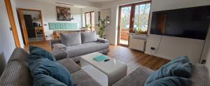a living room with a couch and a tv at Quartier Levi in Oberhausen