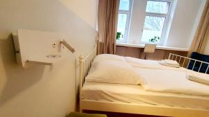 a bedroom with a bed with a sink and a window at Zimmer im Erdgeschoss in Mannheim