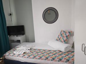 a bedroom with a bed and a mirror and a television at Chance Sarafovo in Burgas