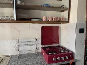 a kitchen with a red stove in a kitchen at Kisumu gateway 2br in Kisumu