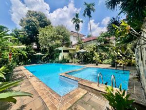 a swimming pool in front of a house at Happy Place Antipolo in Antipolo